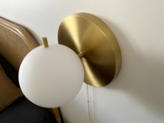 brushed brass round wall lamp with round frosted glass shade